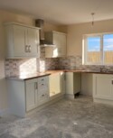 A social housing development in Ballymakenny Road, Drogheda, Co Louth consisting of 50 houses of 3 and 4 bed dwellings along with large green areas planted with native trees and plants. white kitchen