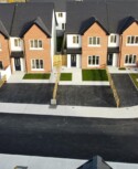A social housing development in Ballymakenny Road, Drogheda, Co Louth consisting of 50 houses of 3 and 4 bed dwellings along with large green areas planted with native trees and plants. row of houses